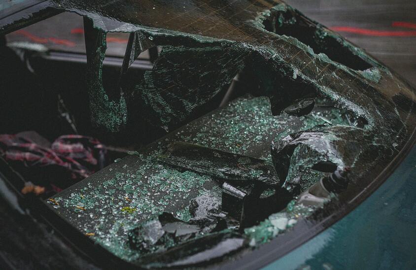 A wrecked car with a broken windshield