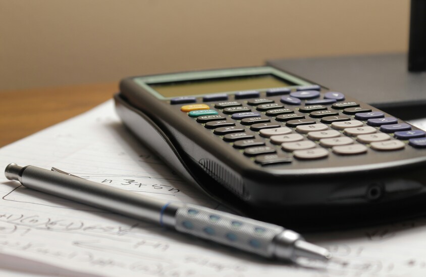 Calculator and pencil on a notebook