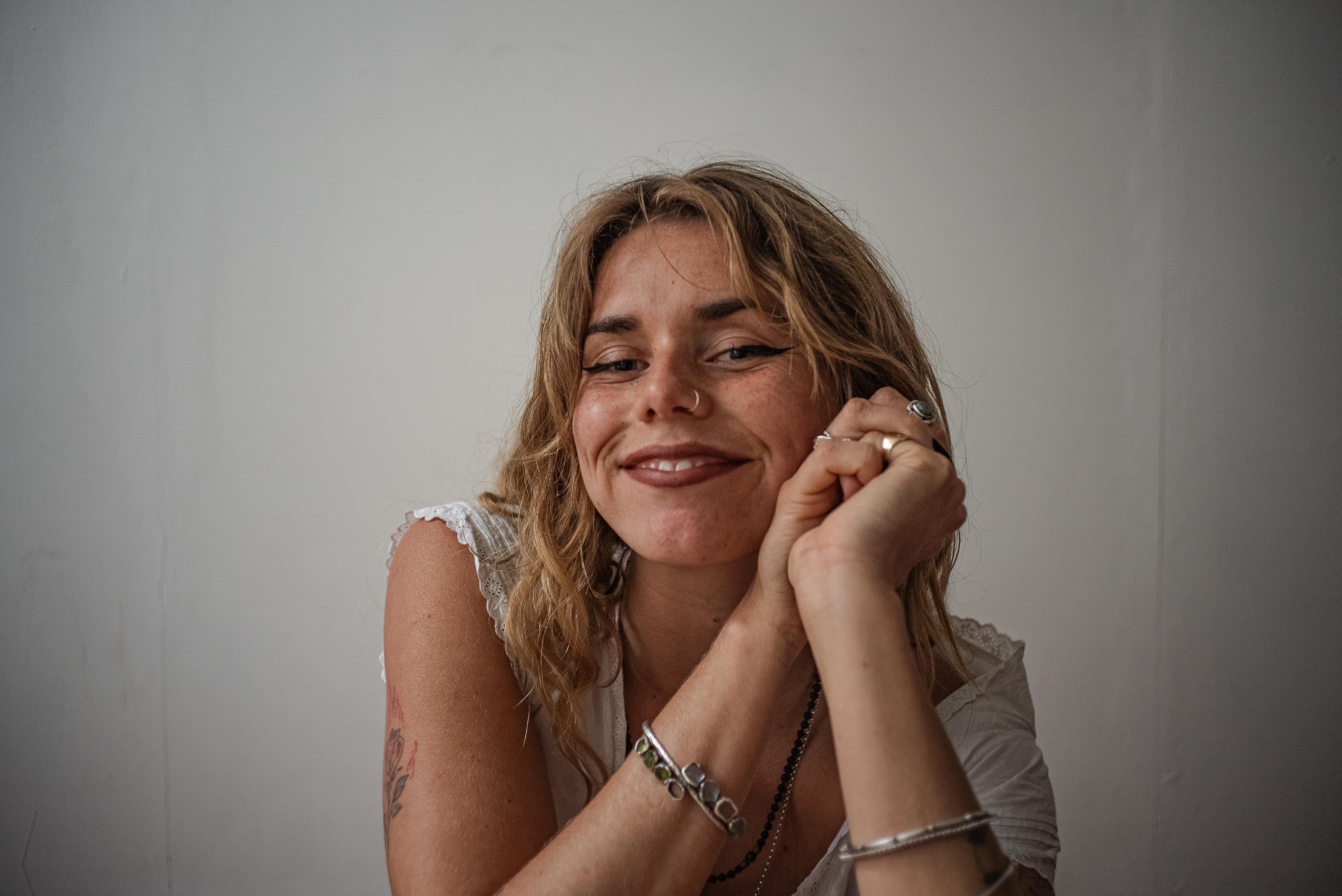 A man wearing white suit looking down.