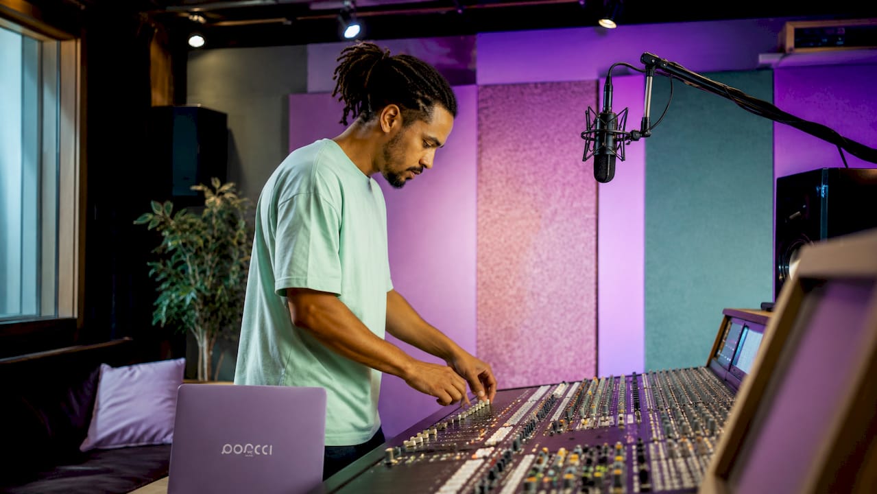Sound technician adjusting audio mixer controls
