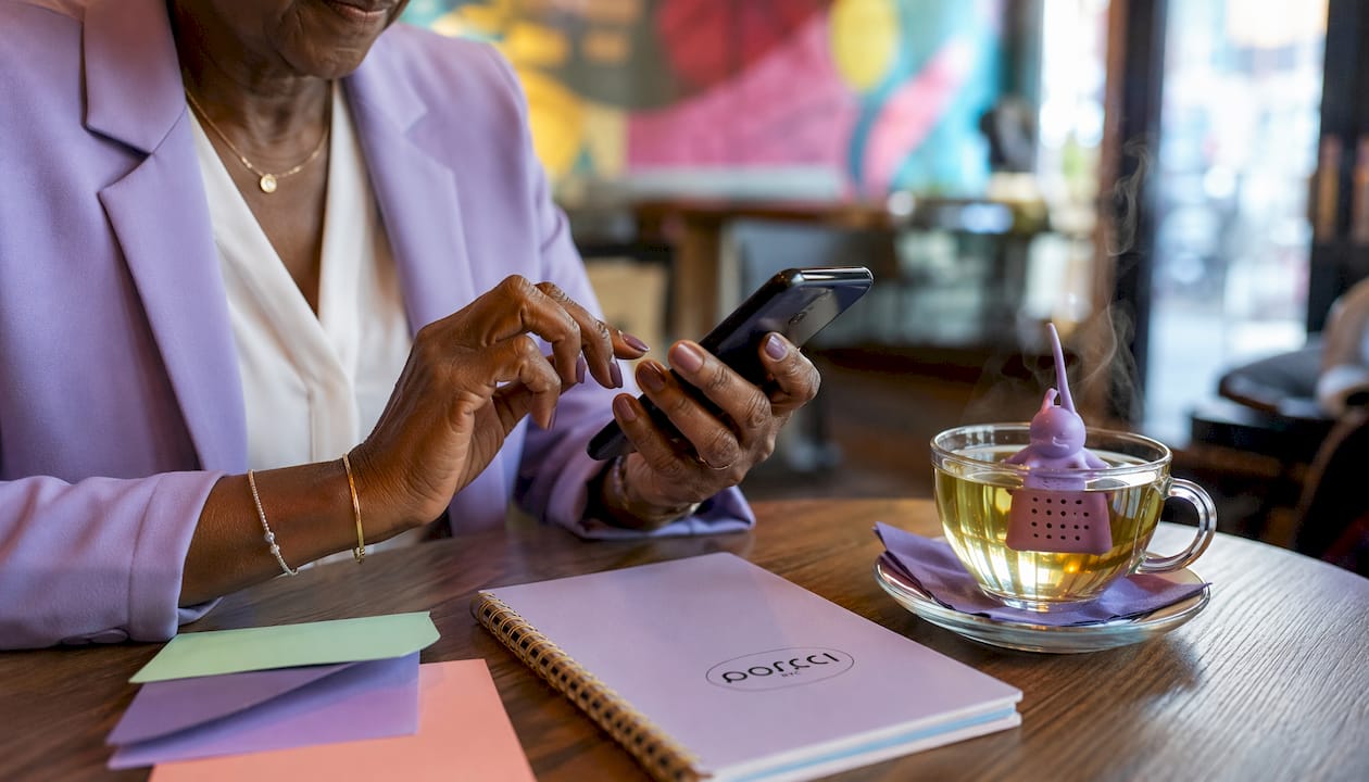 Hands dialing phone for RSVP follow-up