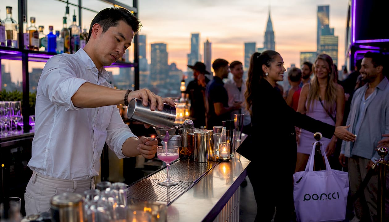 Bartender pouring drink with door host greeting guests