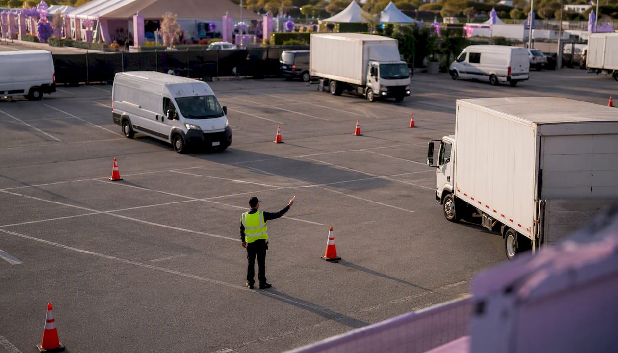 Yard marshal directing delivery trucks