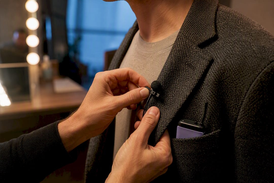 Lavalier microphone clipped beneath jacket lapel