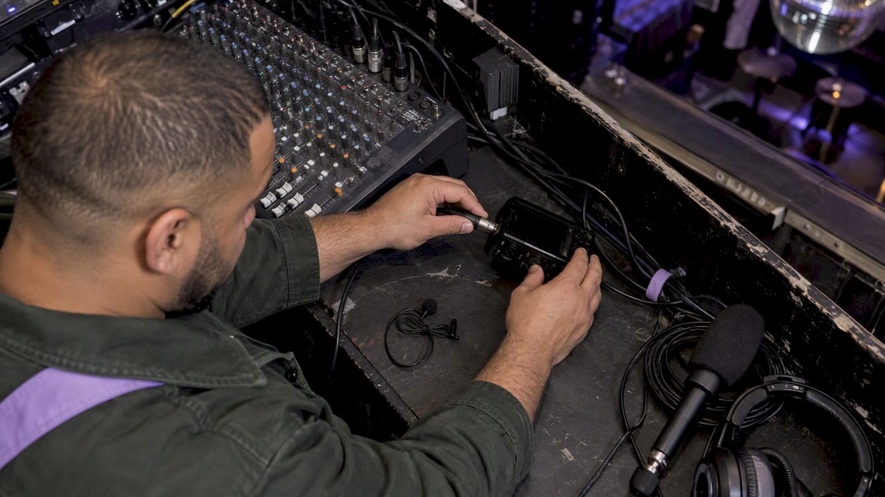 Technician connecting event audio equipment