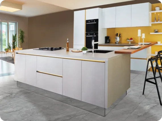 Modern kitchen with a large island, white cabinets, black appliances, and a yellow backsplash.