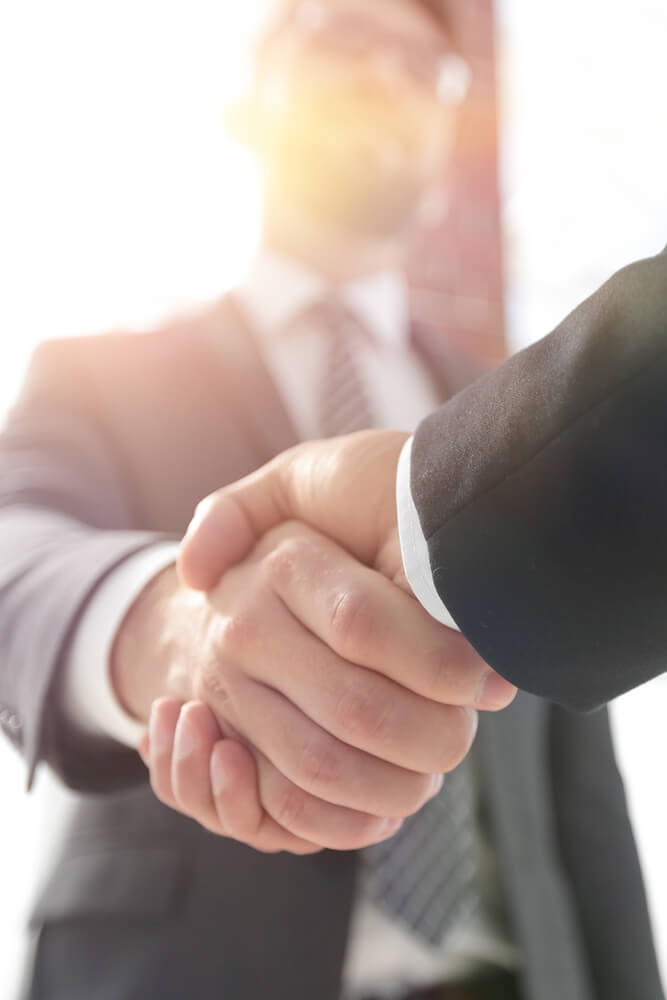 Business handshake symbolizing data outsourcing partnership and reliable data processing services