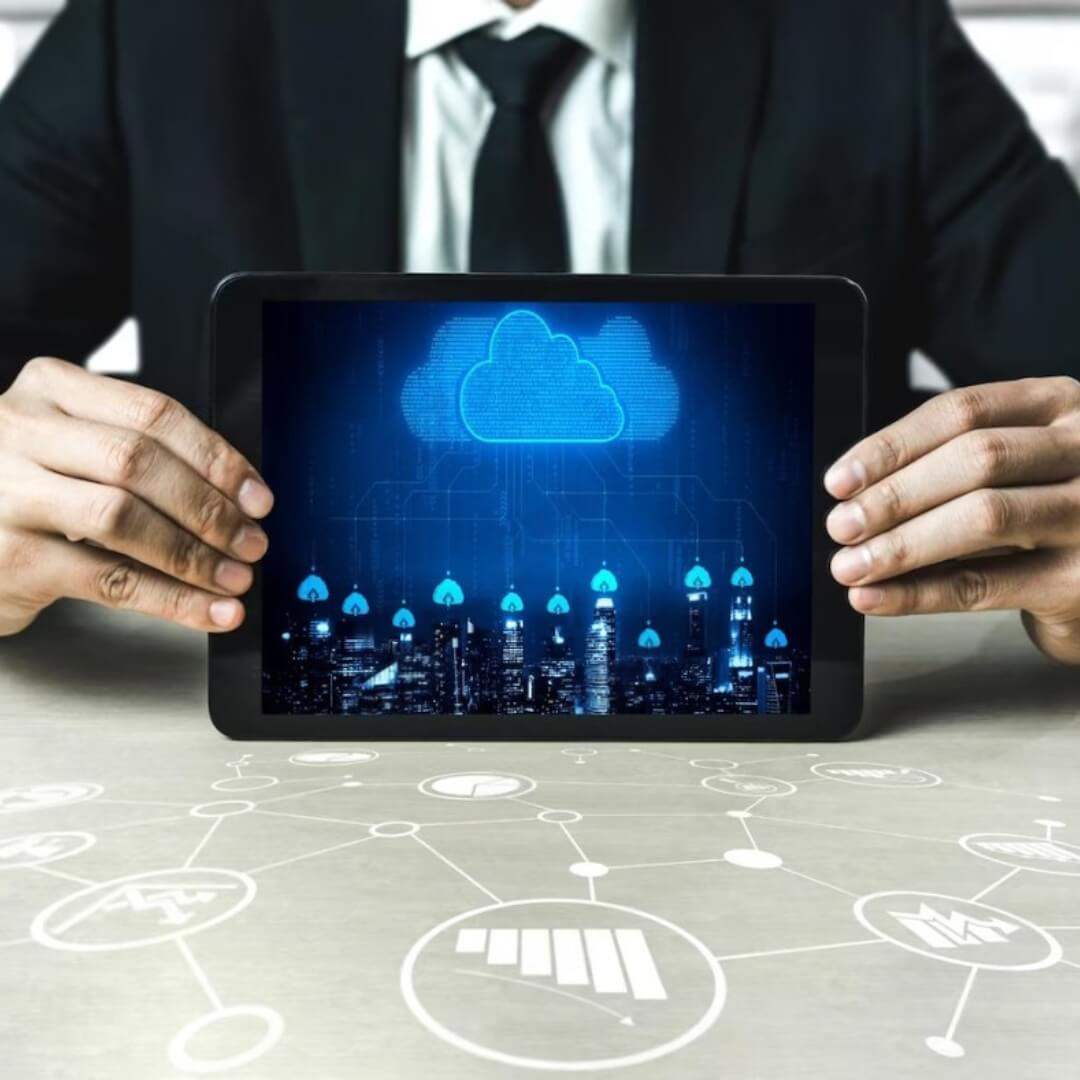 Business professional holding a tablet displaying a glowing cloud network, symbolizing Salesforce development services and cloud-based CRM solutions.
