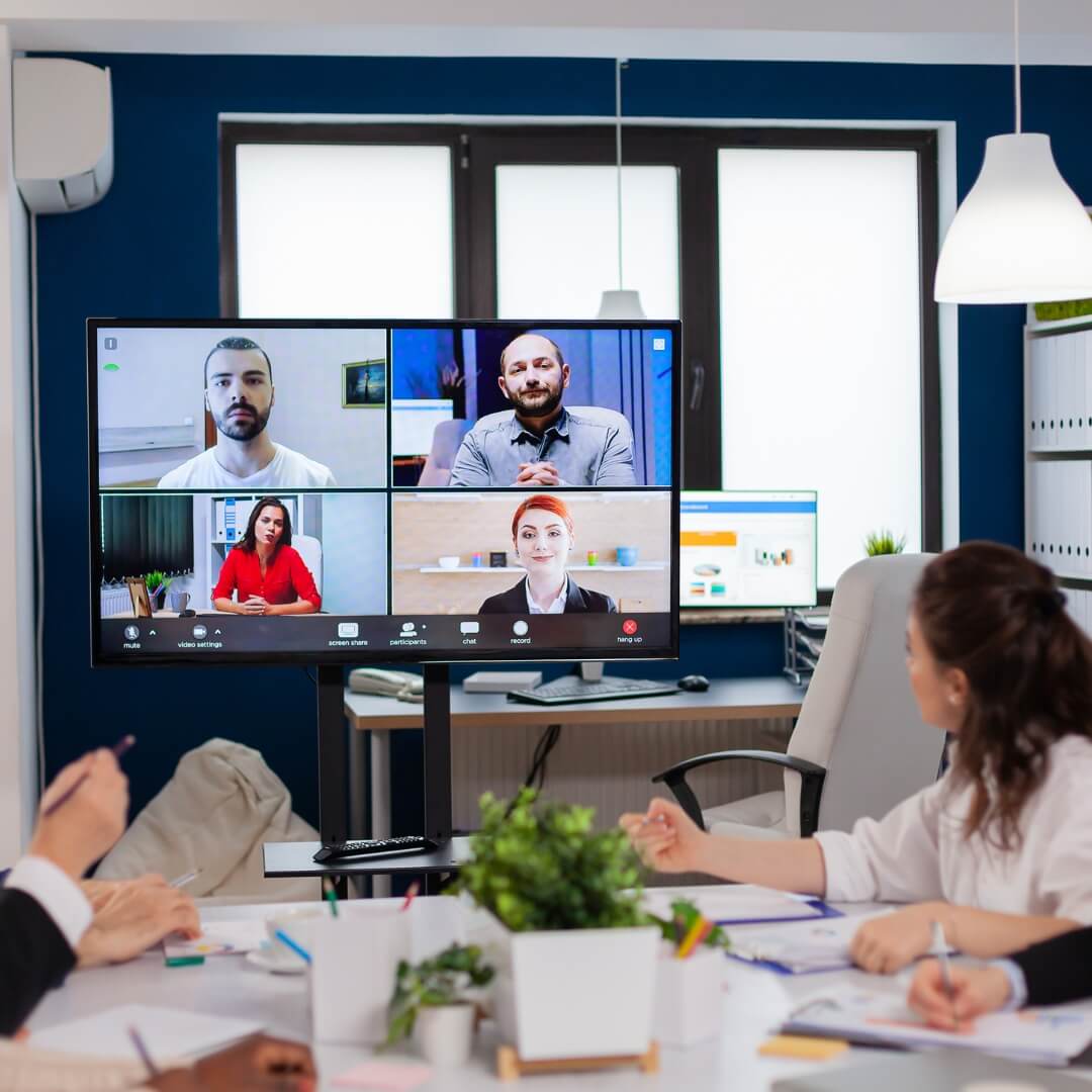 Team attending a video conference with multiple participants on screen, representing dedicated remote teams and virtual collaboration services.