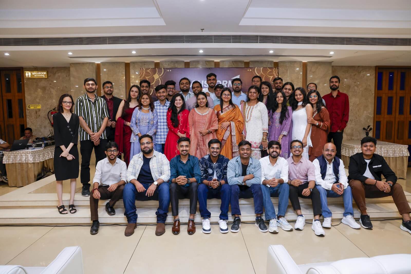 TRANSFORM Solutions employees dressed in ethnic wear standing together and celebrating a festive occasion in the office.