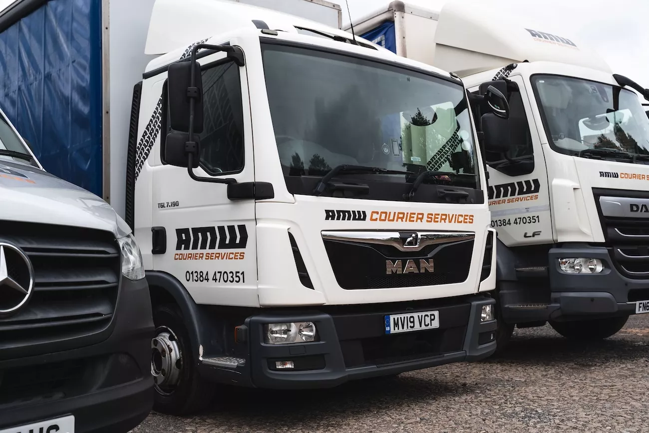 AMW Courier Services fleet of specialist delivery vehicles lined up at depot ready for dispatch