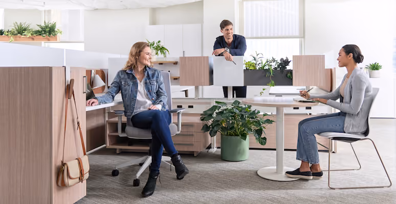 man stretching his arms at his standup desk