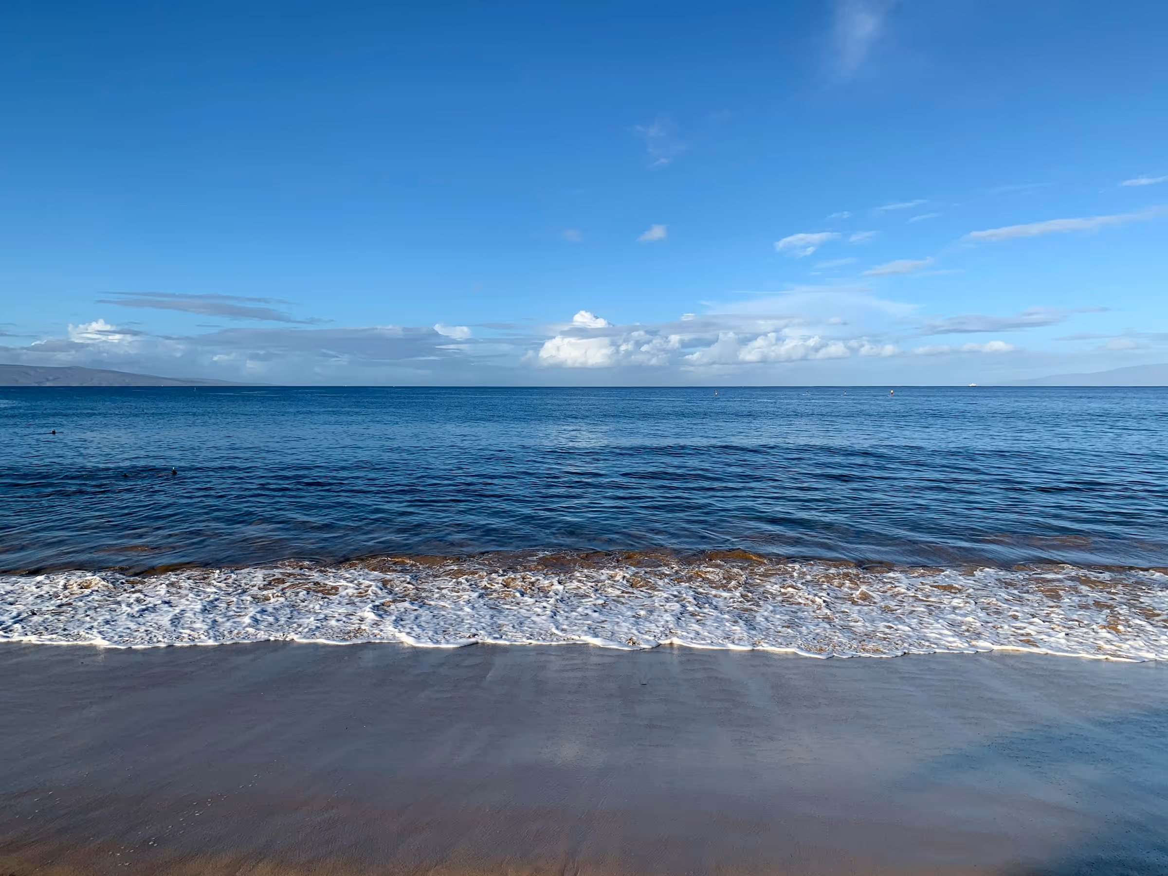 Calm morning at Kamaole Beach Park II in South Kihei, Maui, with golden sand and clear water