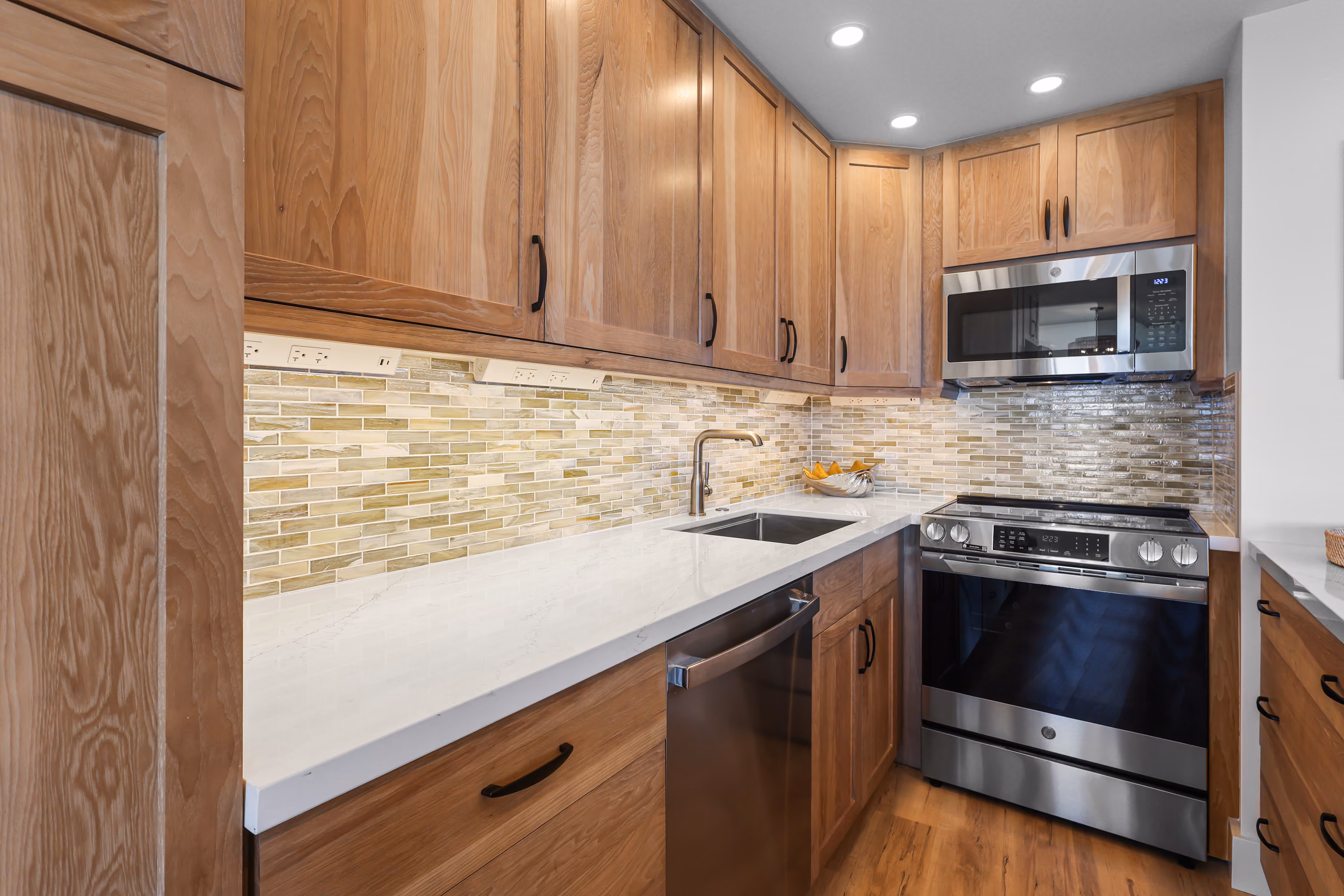 Kitchen with wood cabinets, tiled backsplash and stainless-steel appliances.