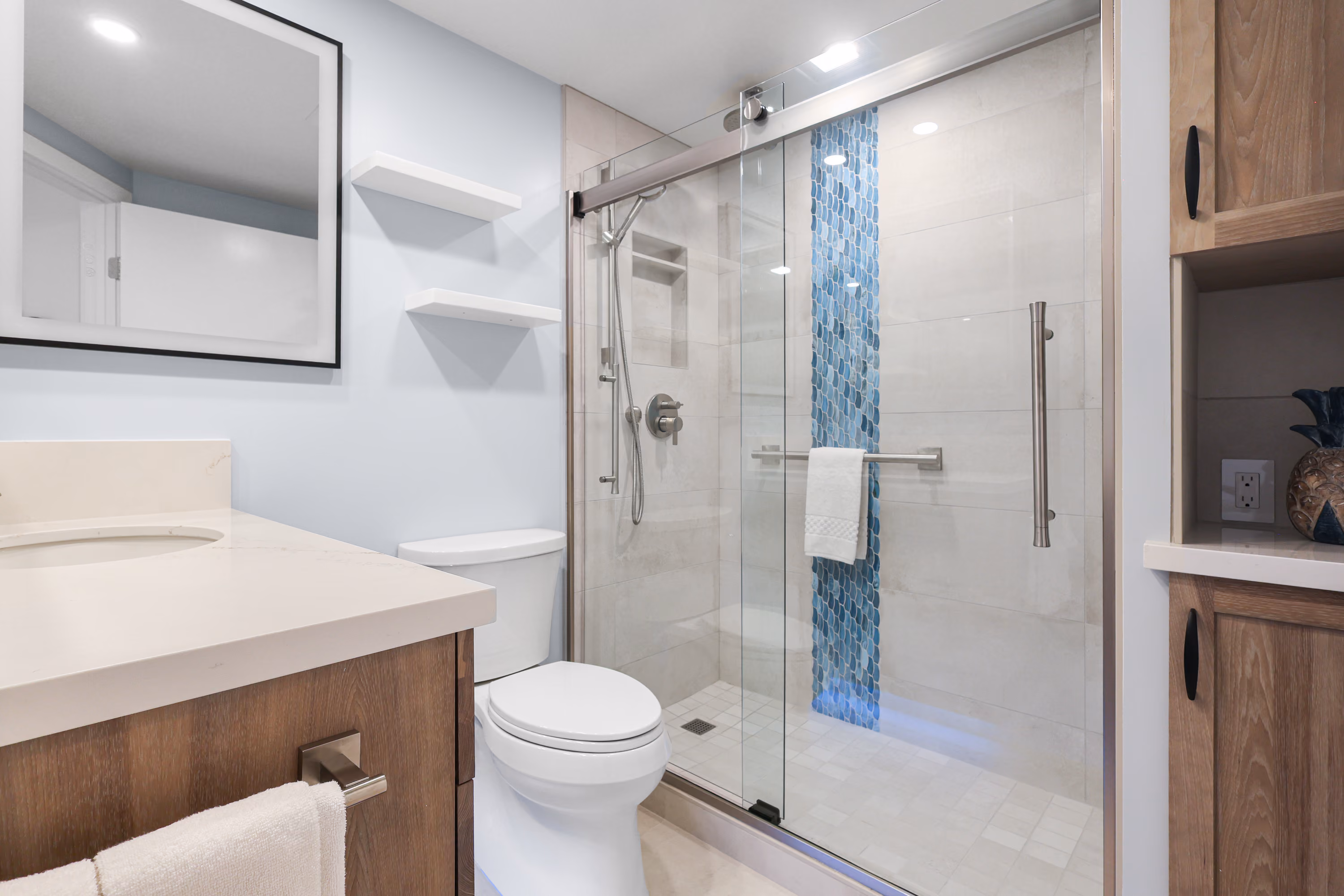 Bathroom vanity beside a glass shower enclosure.