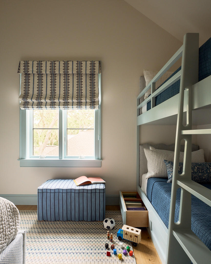 Built-in bunk beds with integrated storage, soft blue millwork, layered bedding, and tailored coastal-inspired textiles in a custom children's bedroom.