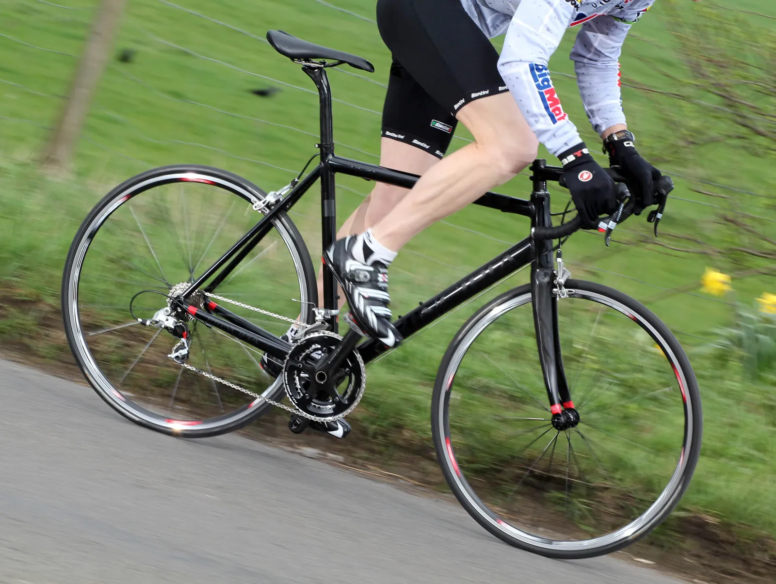 Black Principia road bike on a country road with a cyclist in action
