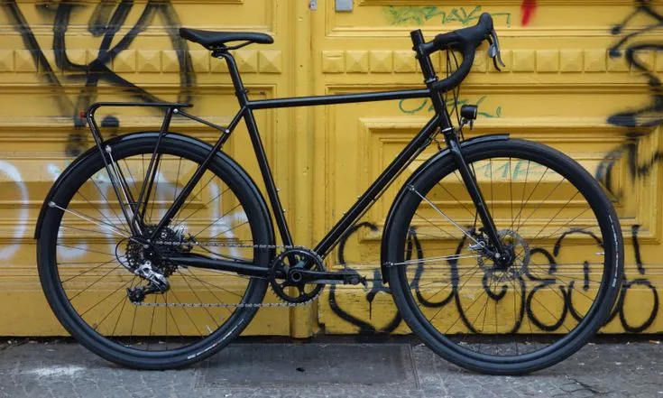 Intec black road bike with a yellow graffiti-style front fender