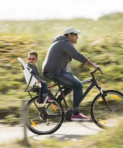Intec black mountain bike with child seat, men and children on a bike path