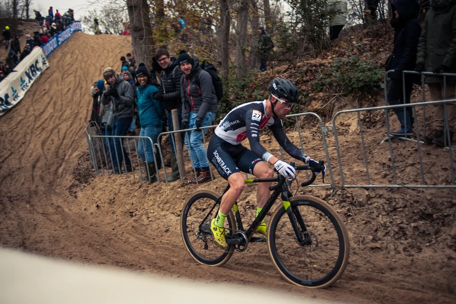 Black and green Bombtrack cyclocross bike on a sandy track during a race