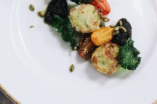 A small serving of vegetables finely presented on a white plate