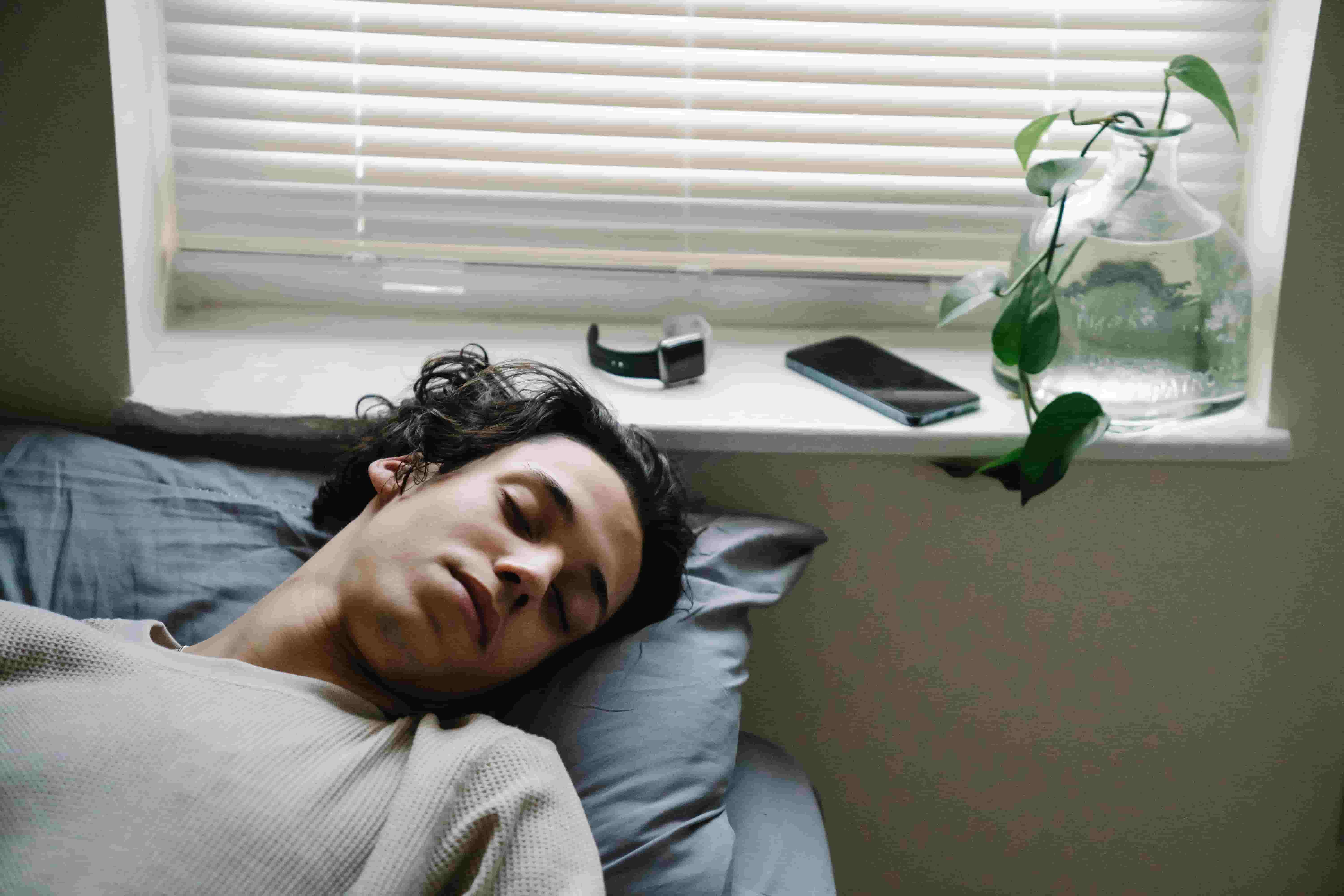A tired Asian man sleeping during the day