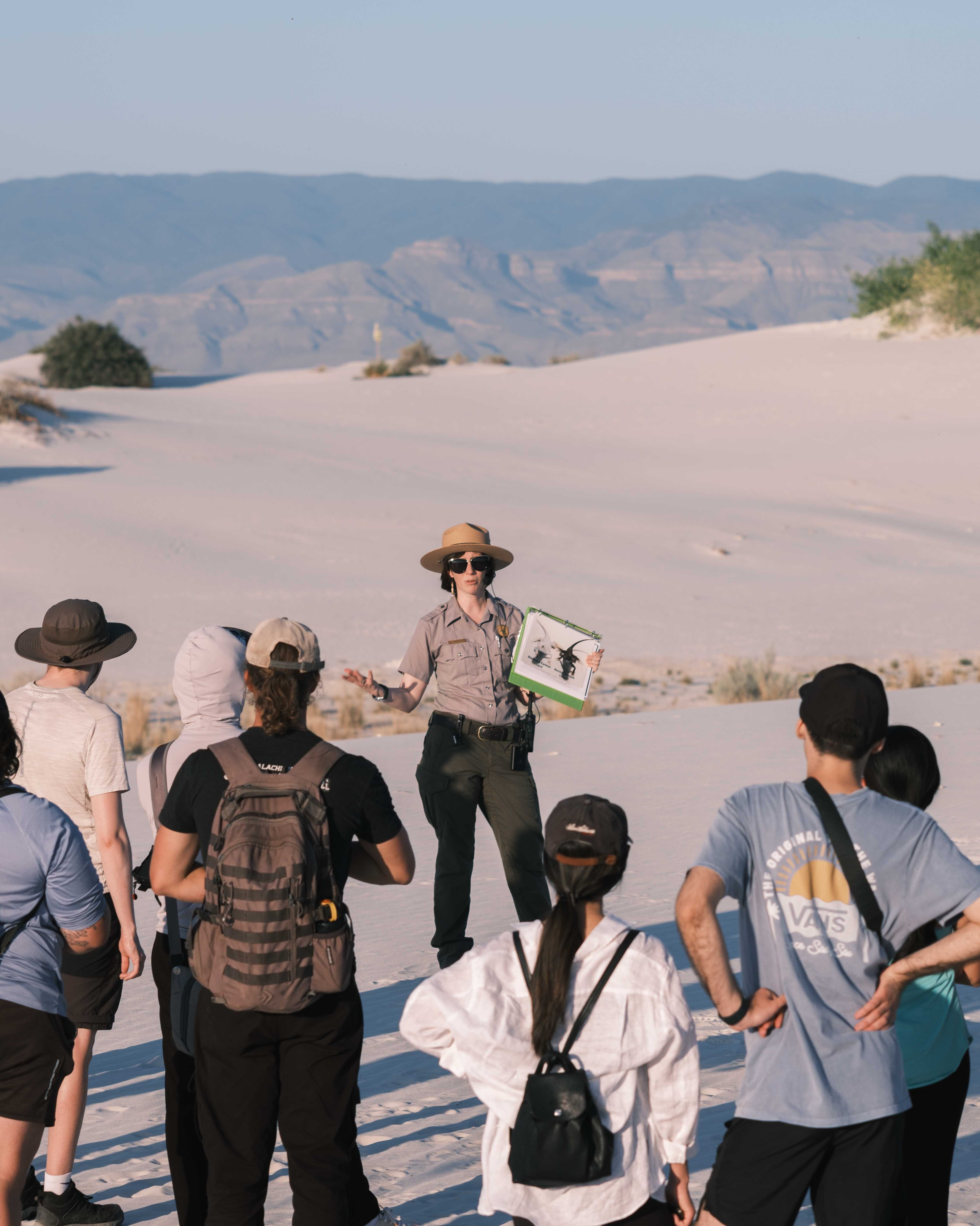 Tour guide speaking to a group of visitors at White Sands National Park, New Mexico.