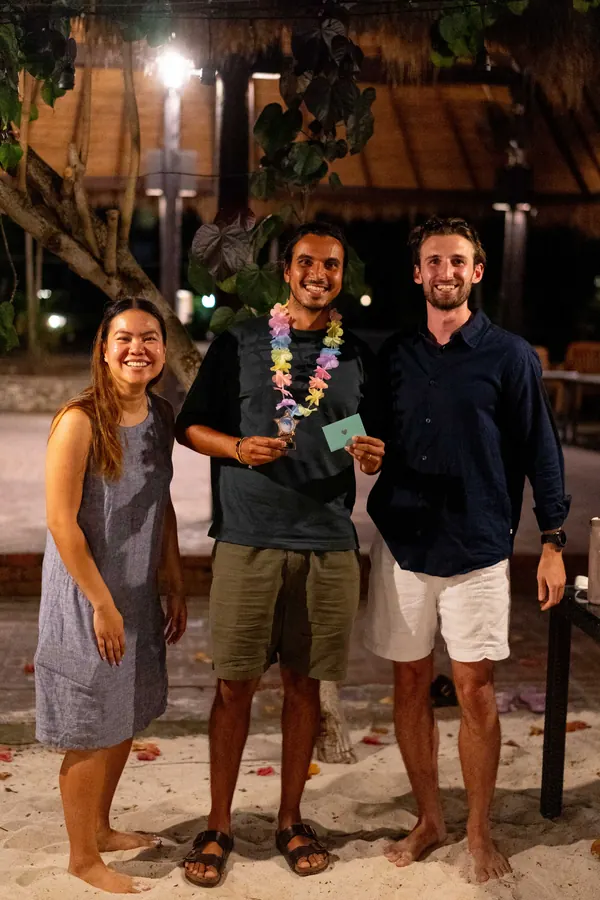 A Gridcogger receiving a trophy at the retreat awards night on the beach