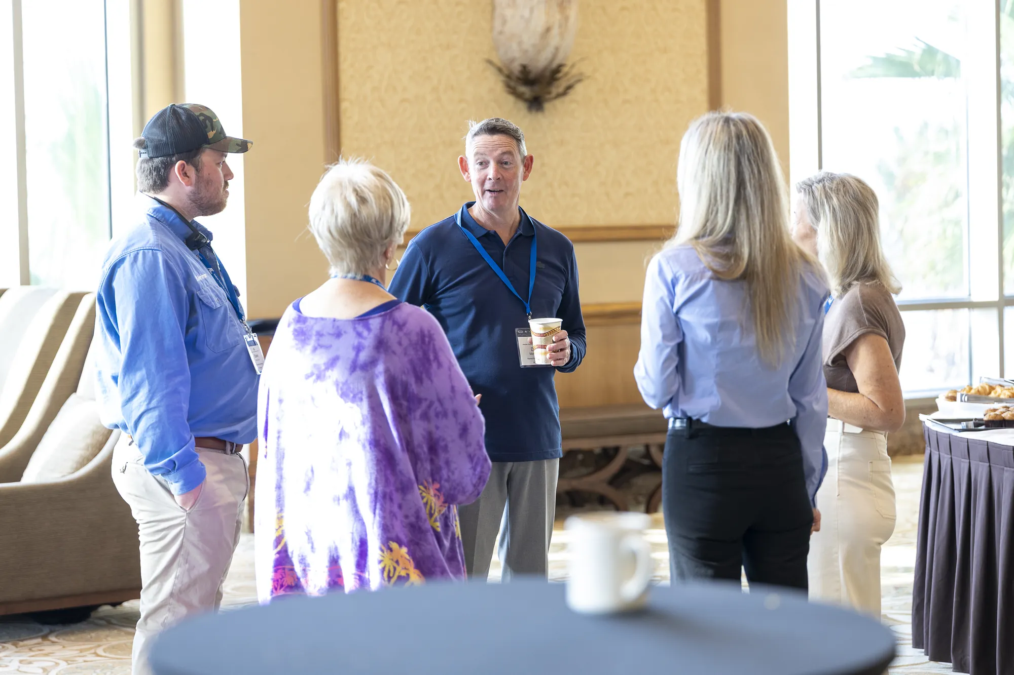 Attendees talking over coffee during a break
