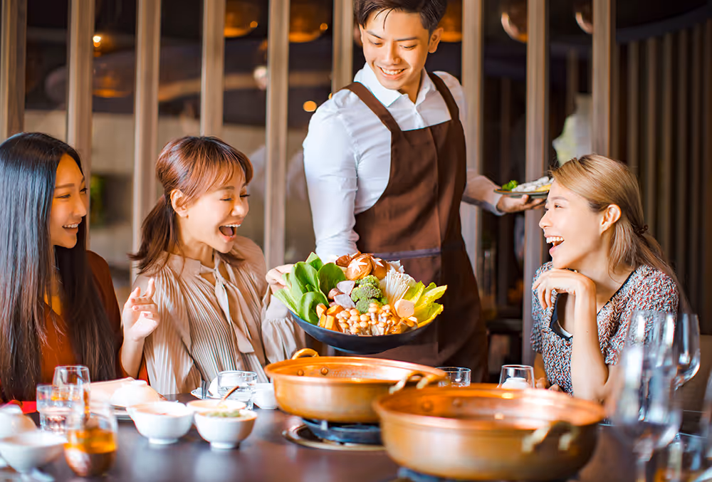 a group of people at a table with food