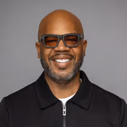 a man wearing glasses and a black jacket