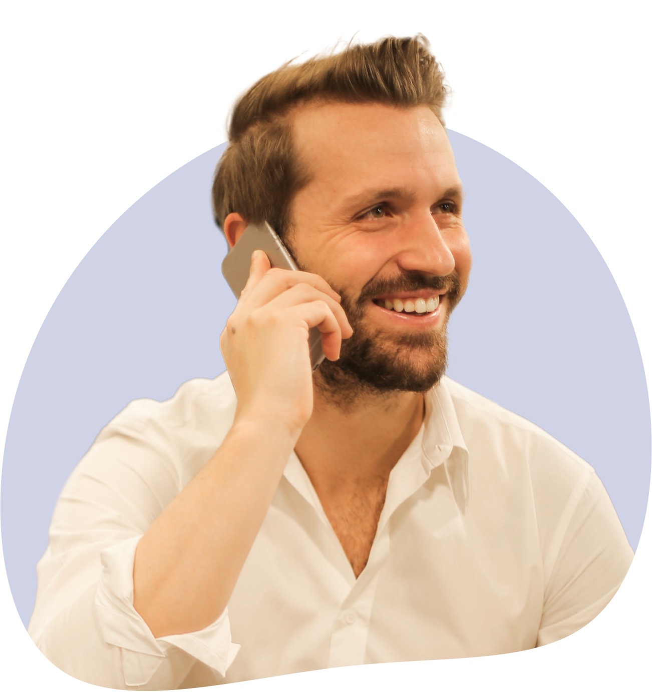 Man in white dress shirt smiling while talking on the phone.