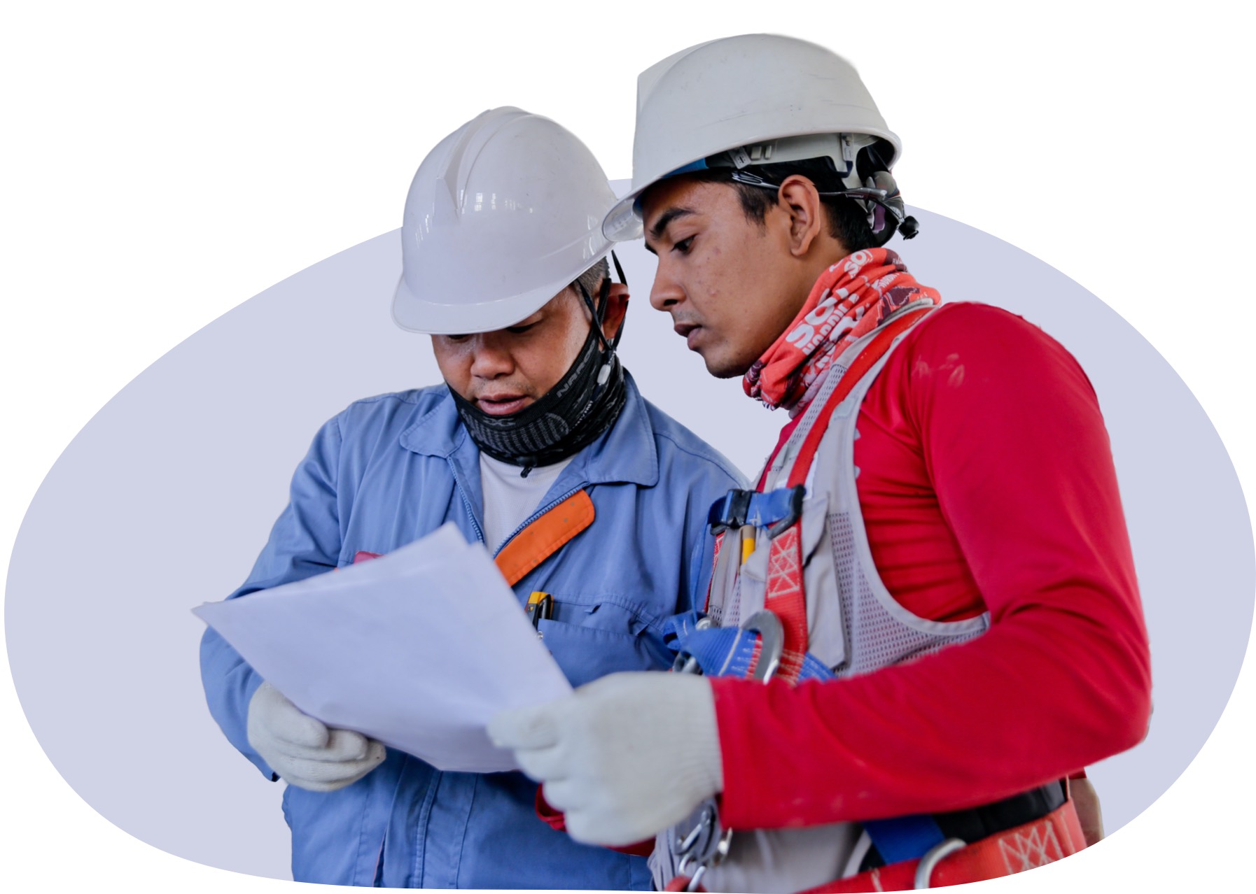 Two construction workers wearing hardhats, looking over a construction plan.