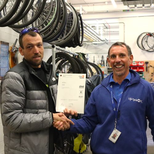 City & Guilds tutor presenting a student certificate of completion