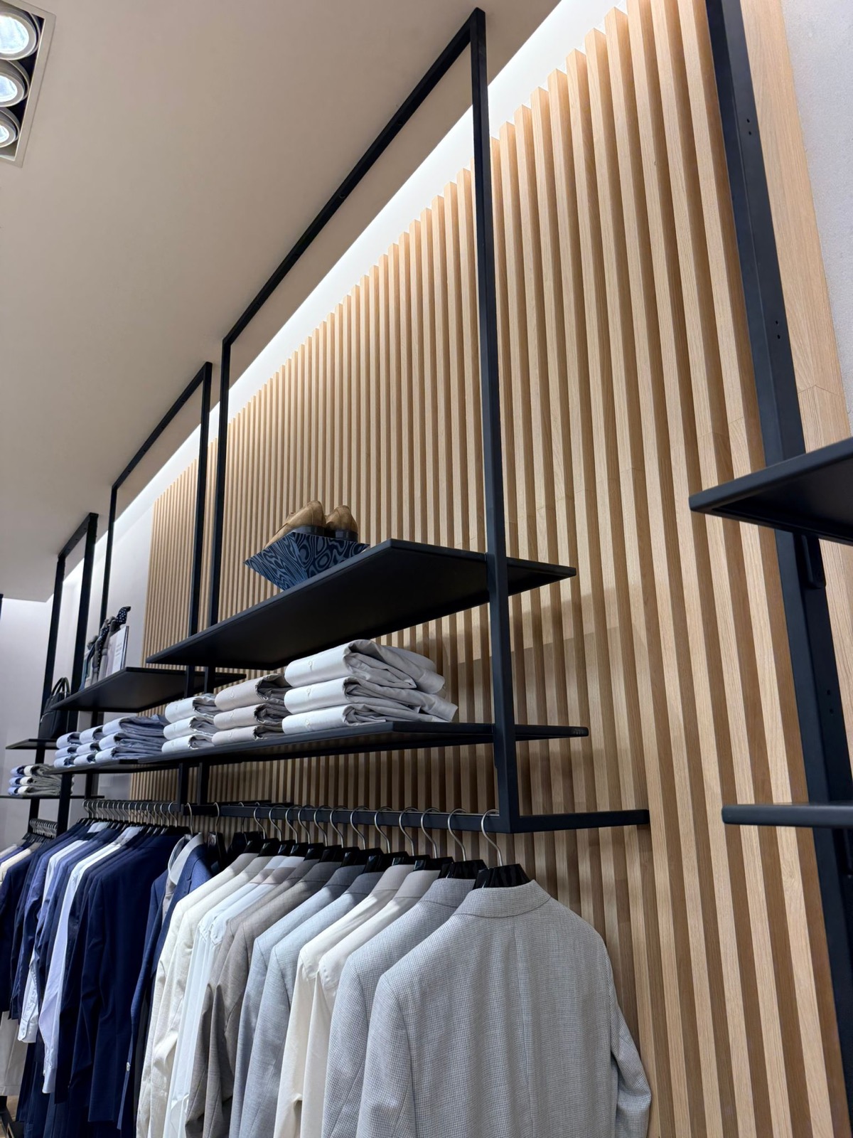 Wood slat wall with black shelving detail