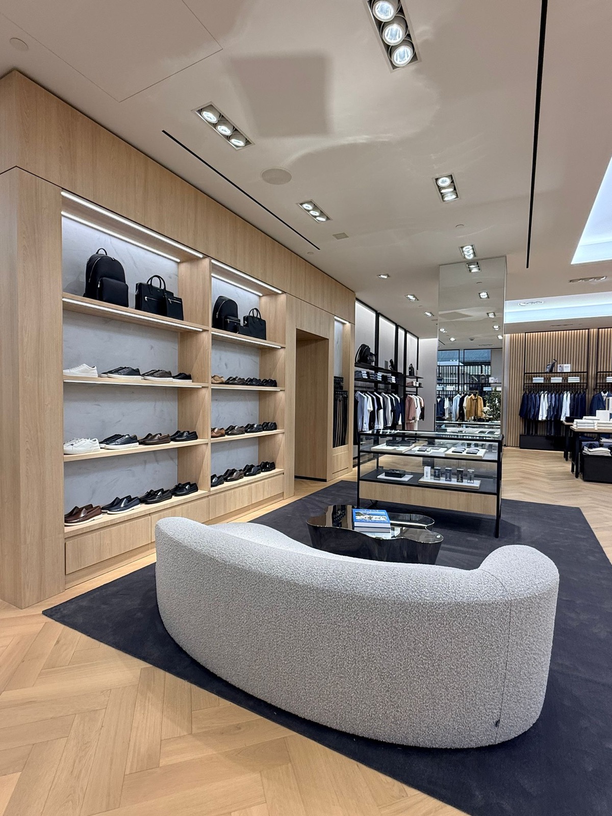 Curved lounge seating beside shoe wall