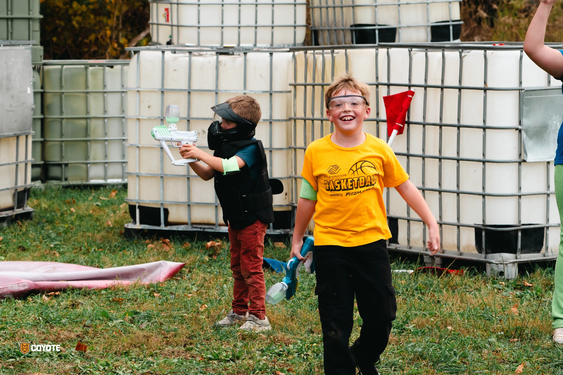 Kids smiling with gellyball blasters at Coyote Field