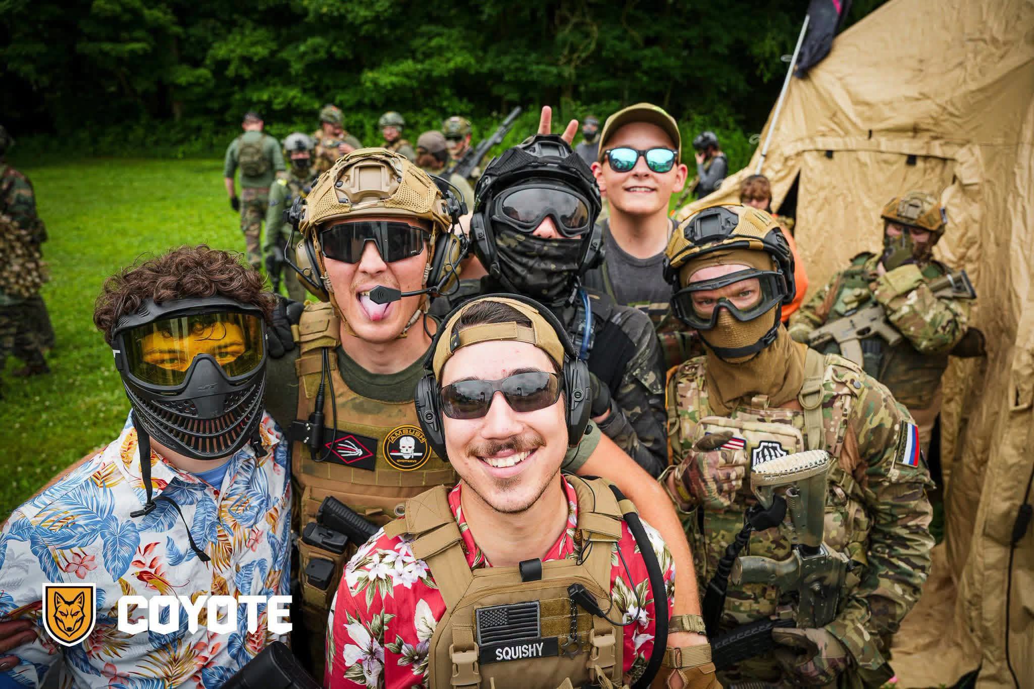 Coyote Force players smiling together in Hawaiian shirts and tactical gear