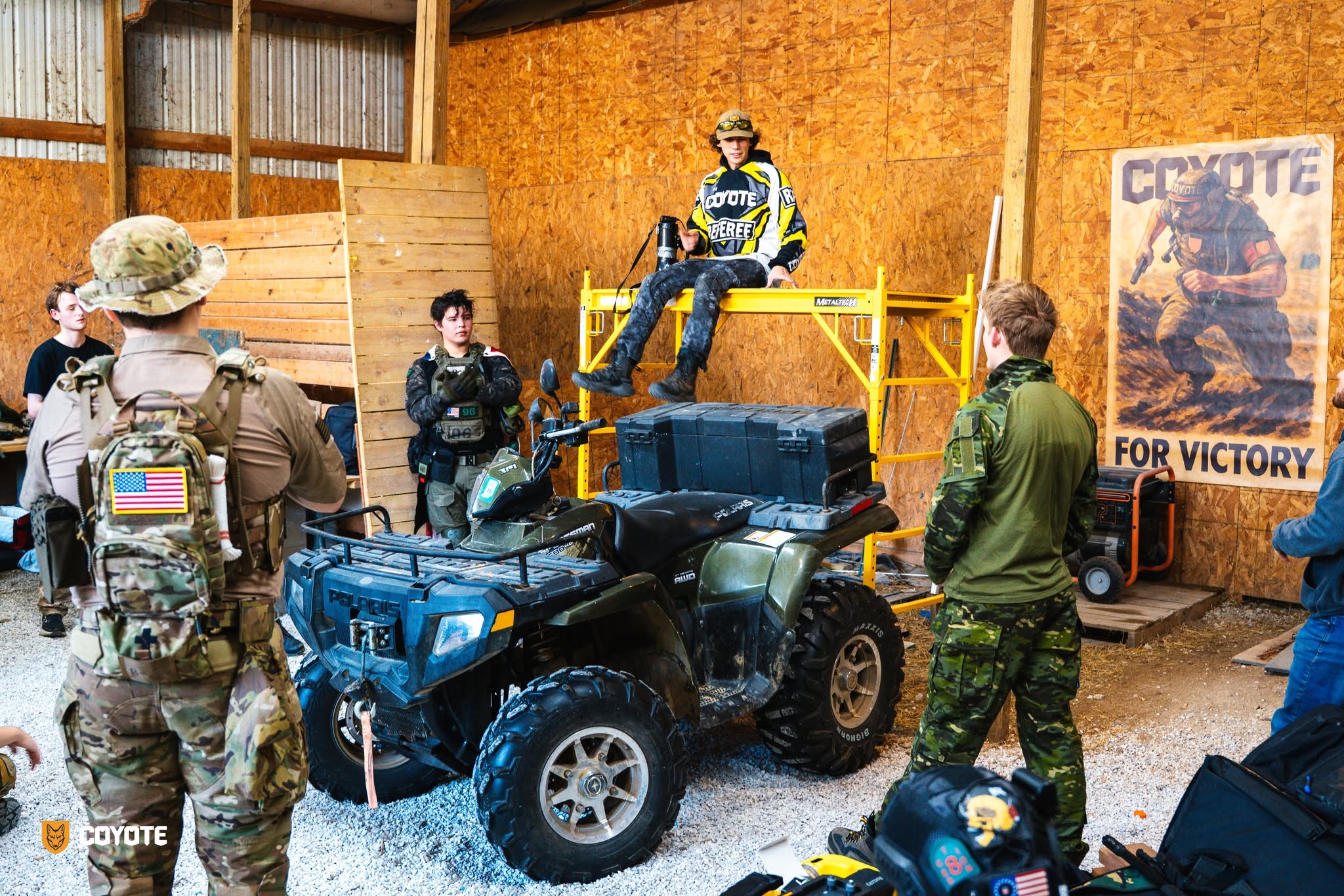 Coyote Force staging barn with referee, ATV, and For Victory poster