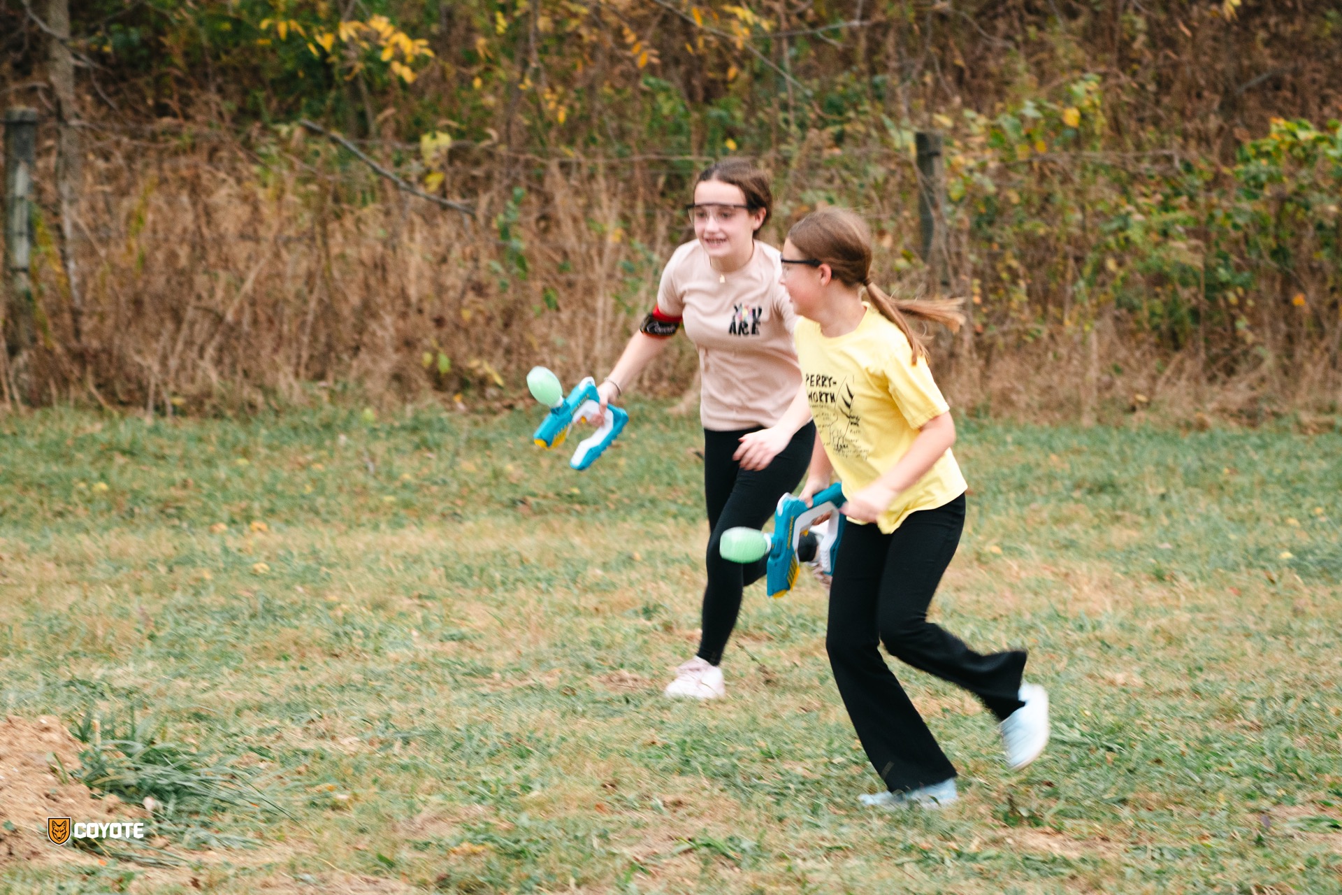 Girls running with gellyball blasters at Coyote Field