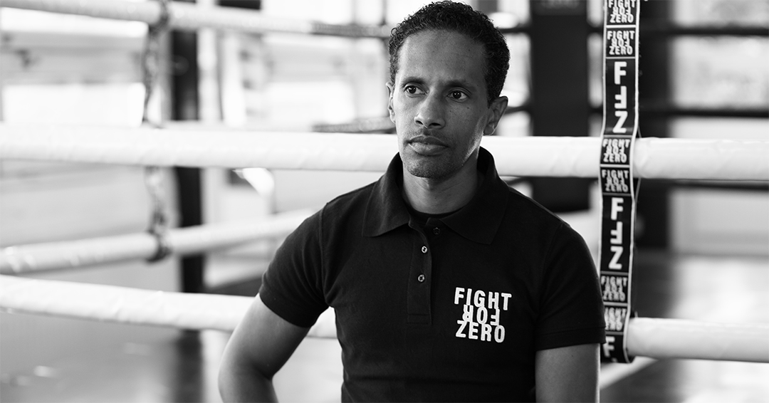 A black and white photo of a boxer looking away 