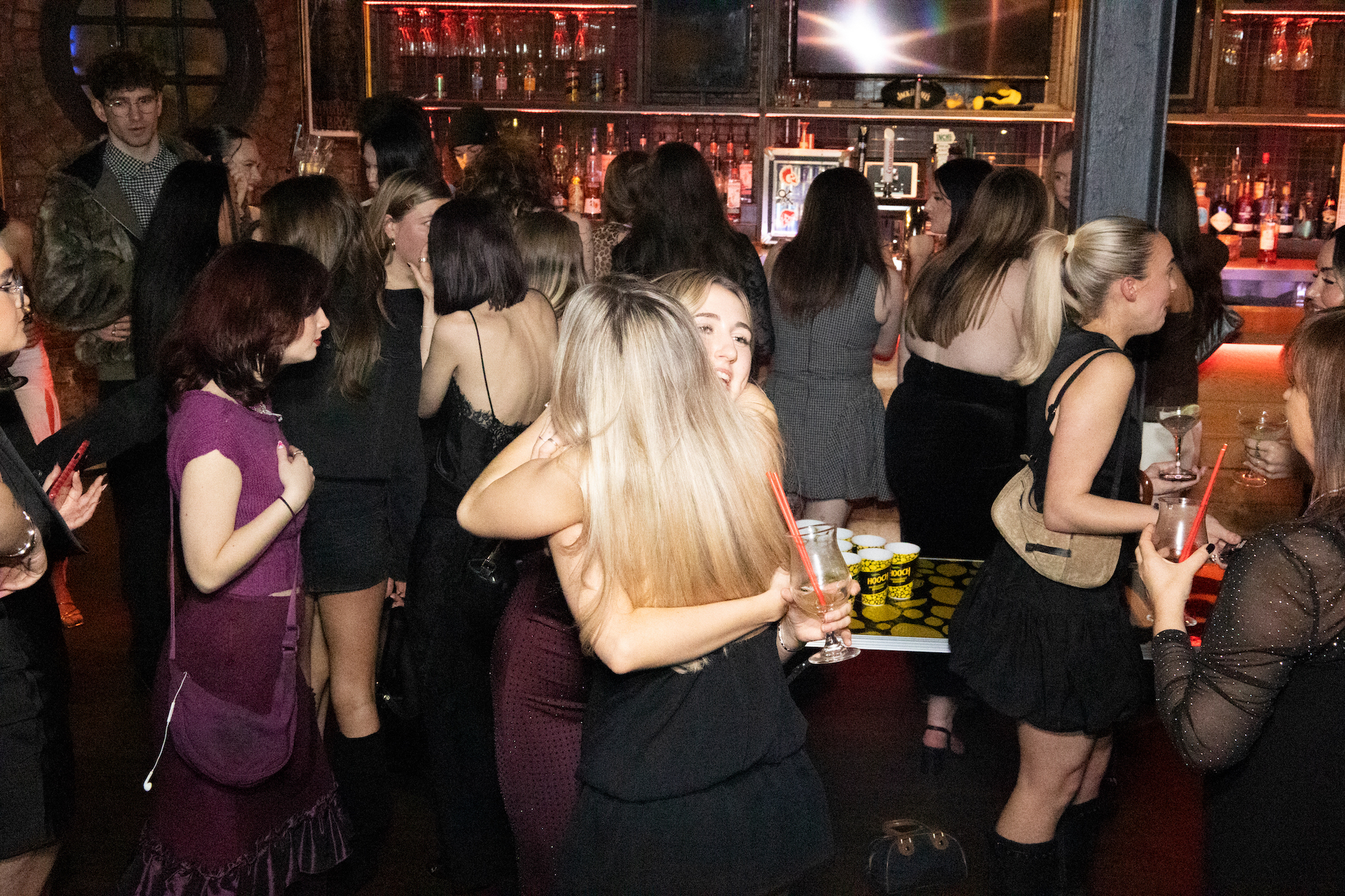 Two girls hugging each other happily.