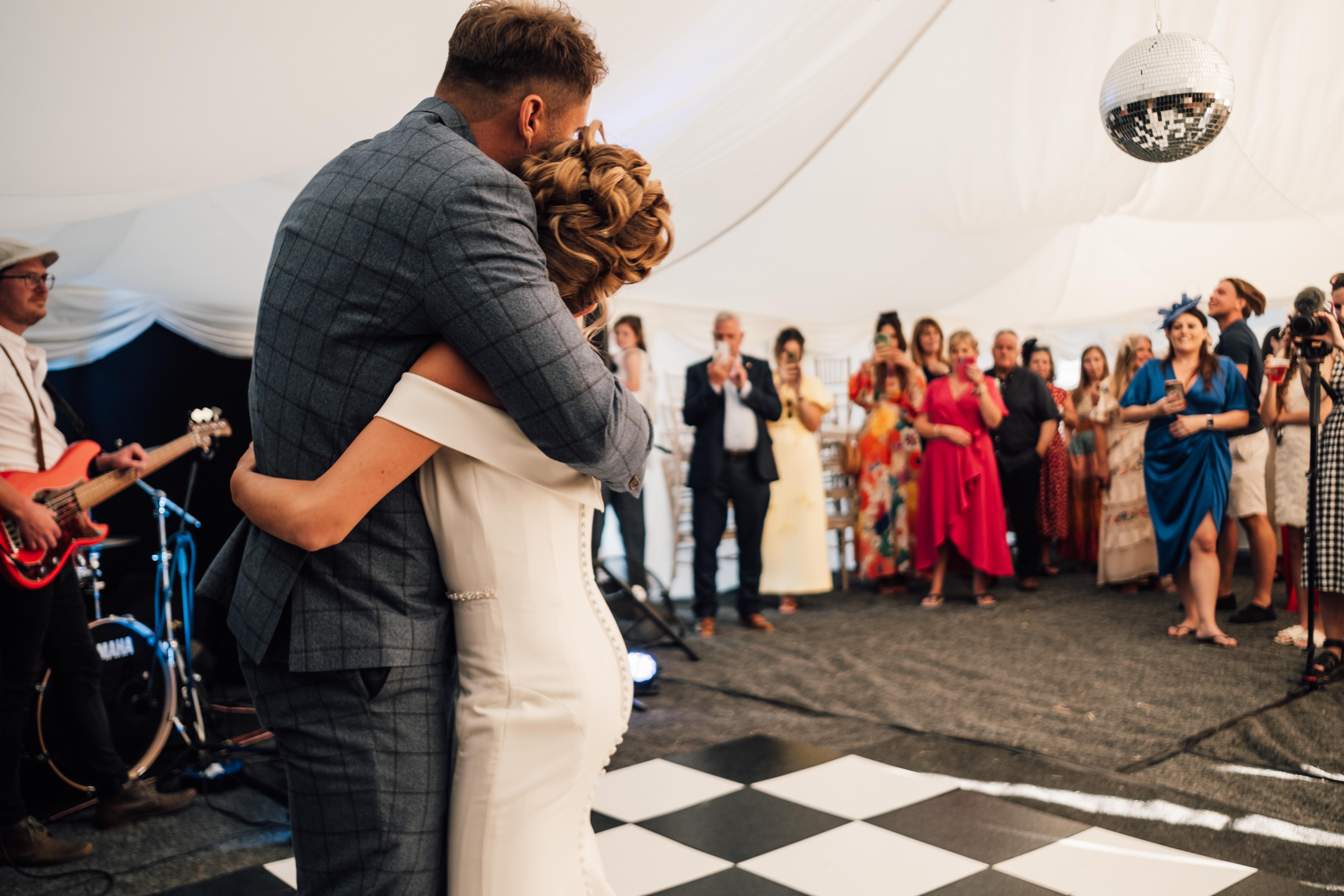 Bride and groom hug on the dancefloor, Kent Wedding Photographers