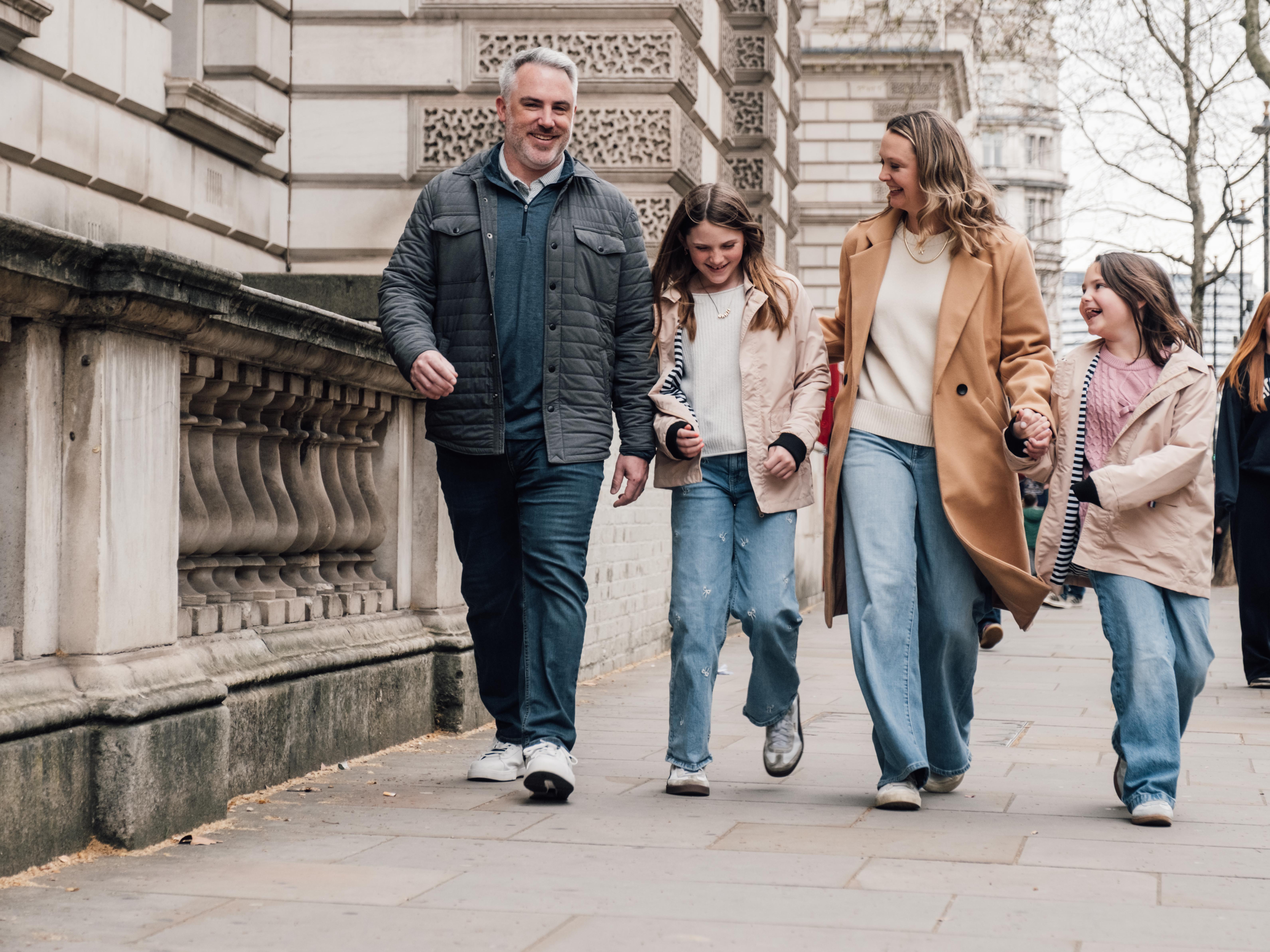 Bride and groom laughing joyfully outdoors during wedding celebration.