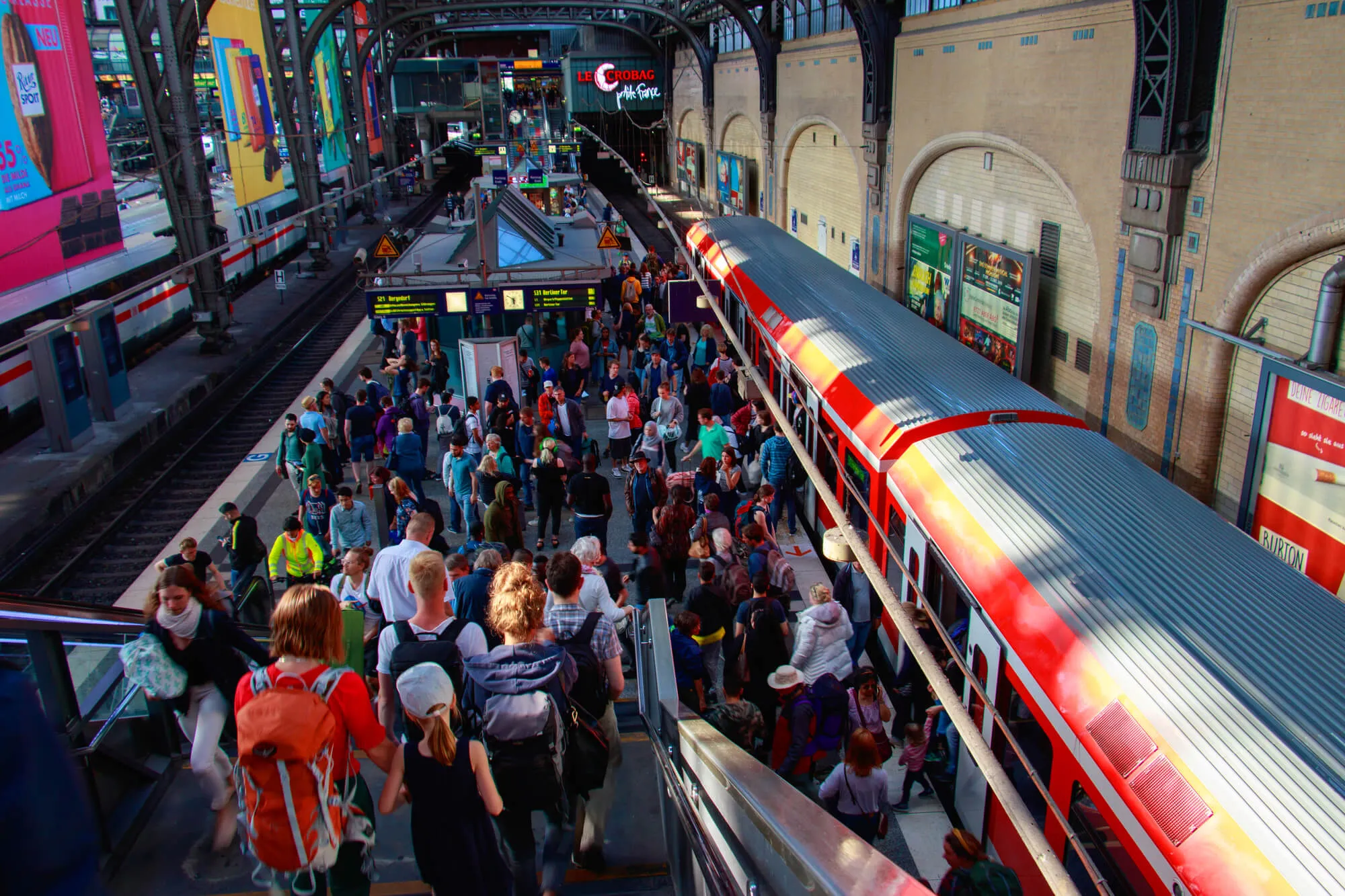 Train station full of people waiting on the platform
