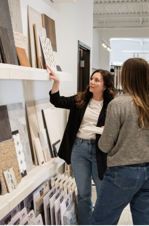 Kim, VP of Pre Construction, guides a client through wood finish and pattern selections.