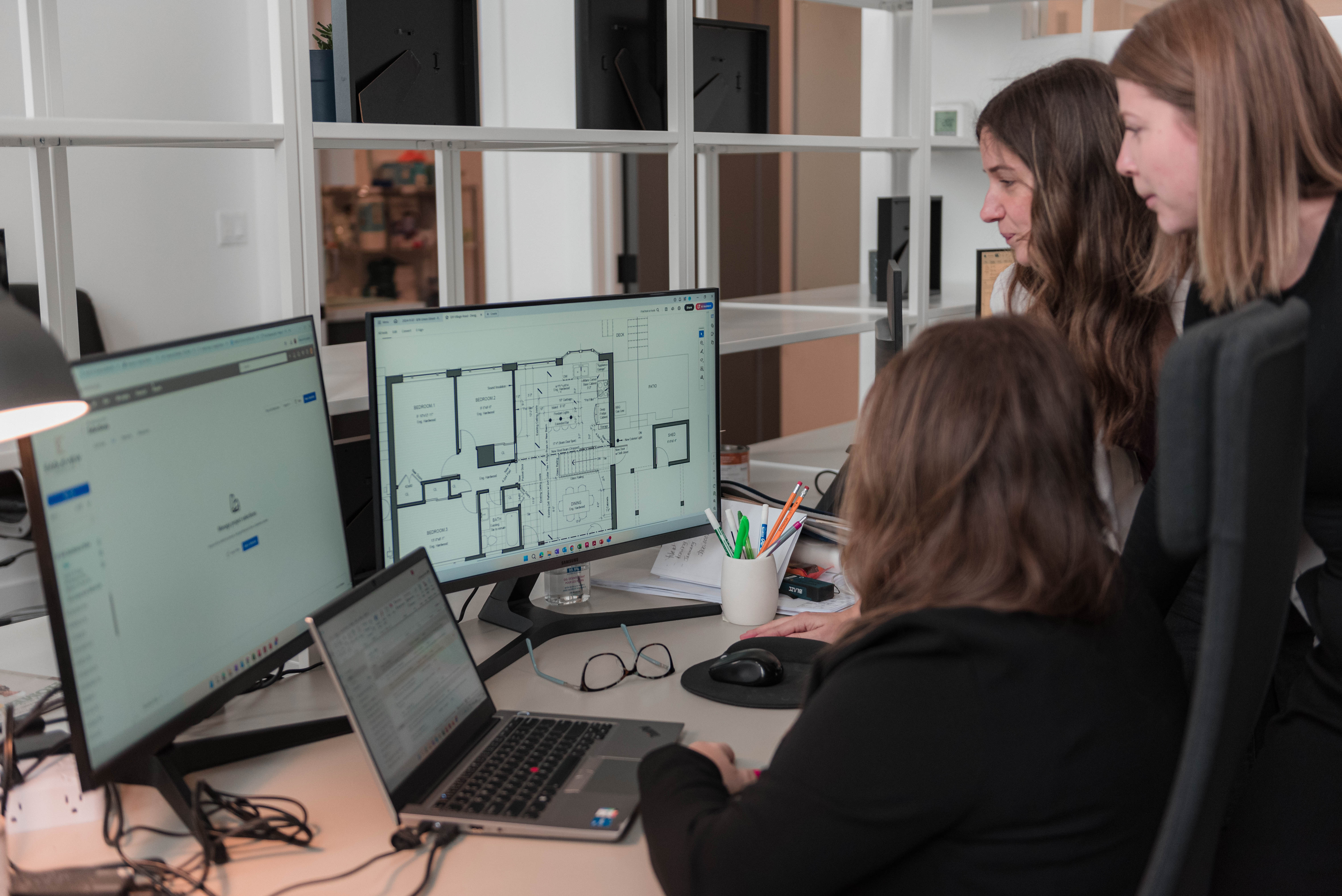 Members of Eagleview’s design-build team reviewing architectural plans for an upcoming project.