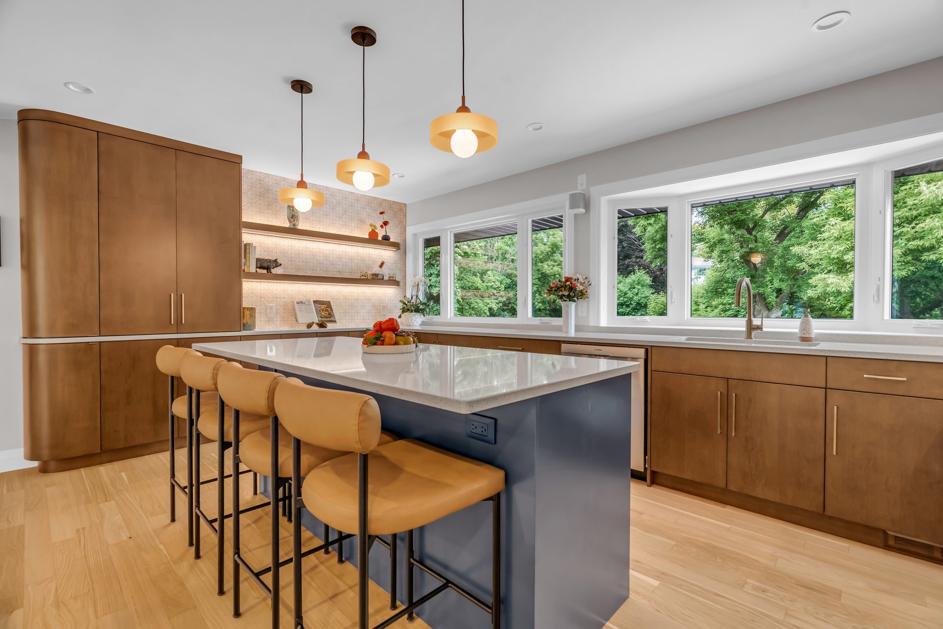 A Forest Hill kitchen renovation with walnut cabinets, a blue island, and leather bar stools