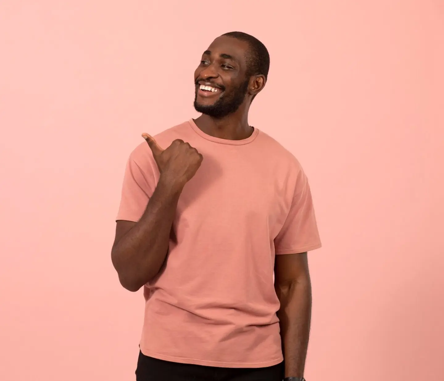 A black man with pink t-shirt in a light pink background