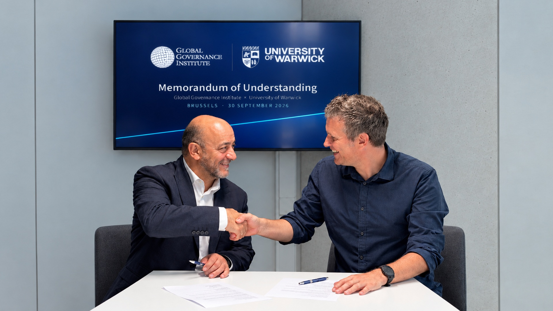Representatives of the University of Warwick and the Global Governance Institute shake hands at the signing of their Memorandum of Understanding in Brussels